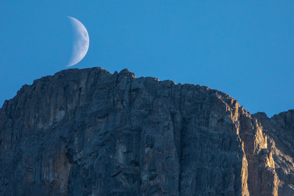 A waxing crescent moon sets behind the Faith of the Three Sisters in Canmore on Friday (Aug. 13). EVAN BUHLER RMO PHOTO