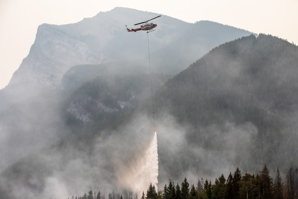 Alberta Wildfire helicopters aerially assists firefighters on the ground as a wildfire burns at the base of Pigeon Mountain near Dead Man's Flats on Saturday (Aug. 14). Crews continued to work on the fire through Friday night and throughout the day on Saturday. The size of the fire was reduced from 10 hectares to 6ha., but the wildfire remains out of control. EVAN BUHLER RMO PHOTO