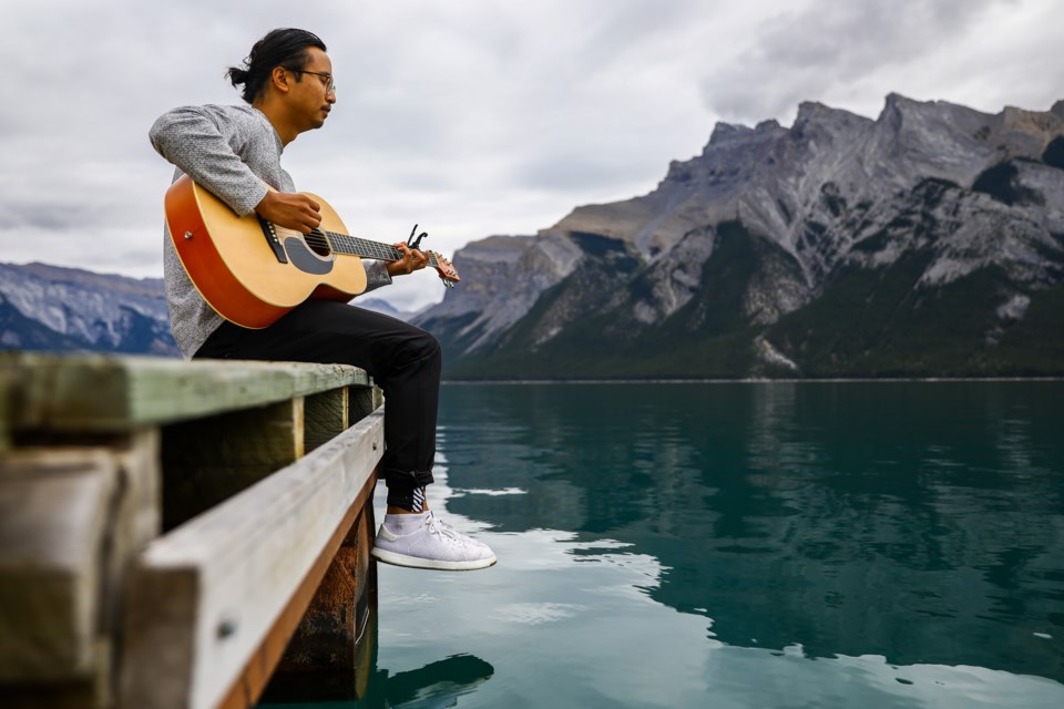 John Garcia plays guitar and sings at the end of the dock at Lake Minnewanka in Banff National Park on Thursday (Sept. 2). EVAN BUHLER RMO PHOTO