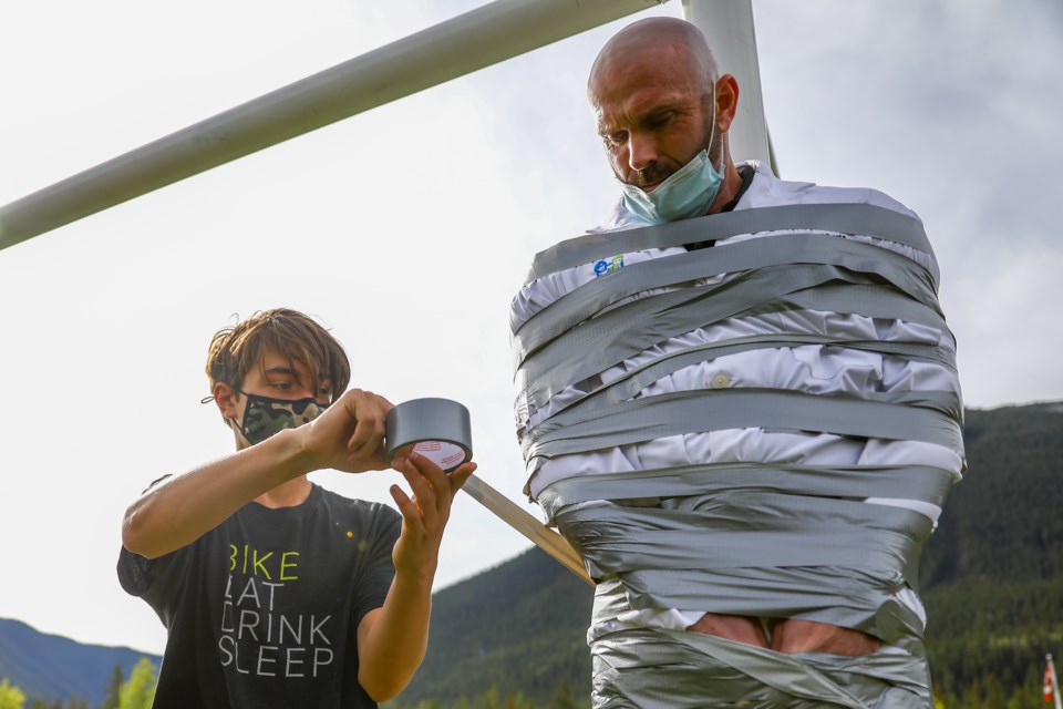 Grade 9 Our Lady of the Snows Academy student Emmett Macklem helps to duct tape OLS principal Jamie Landry to a soccer goal post on Friday (Sept. 17). The stick it to principal event was part of the welcome back week for middle school students at OLS. Twelve tickets were handed out in each of the six middle school classes to students that answered a set of questions correctly. One ticket equaled one wrap of duct tape. EVAN BUHLER RMO PHOTO