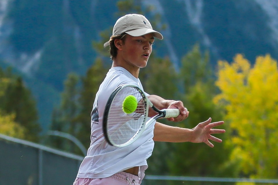 Maxence Schmidt hits a forehand shot while playing tennis at Lions Park in Canmore in 2021. RMO FILE PHOTO