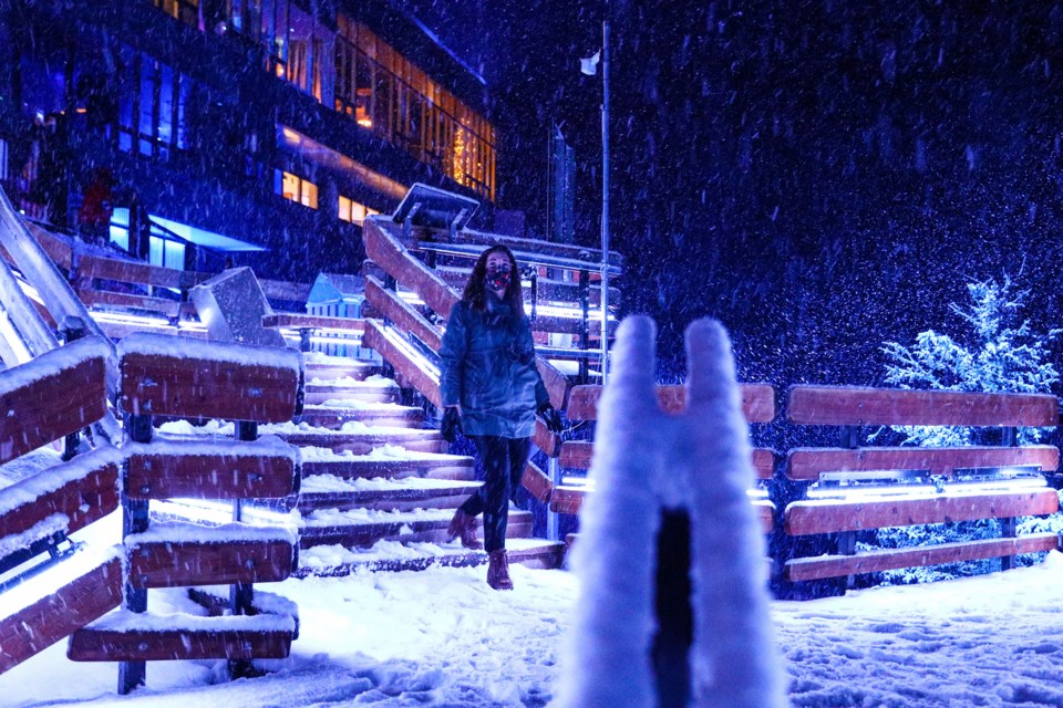 Jane Beauchamp walks through a light and sound display at Nightrise, an immersive art installation at the Banff Gondola during a heavy snowfall in Banff in December 2021. The winter event was created by Pursuit, Montreal's Moment Factory and Stoney Nakoda First Nation, and this year, runs until March 31.

RMO FILE PHOTO