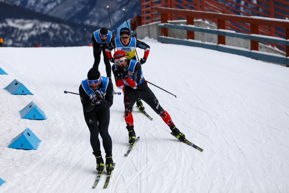 Vladimir Udalstov of Russia is chased down by Brian McKeever of Canada at the 2021 World Para Nordic Skiing World Cup at the Canmore Nordic Centre in Dec. 2021. RMO FILE PHOTO