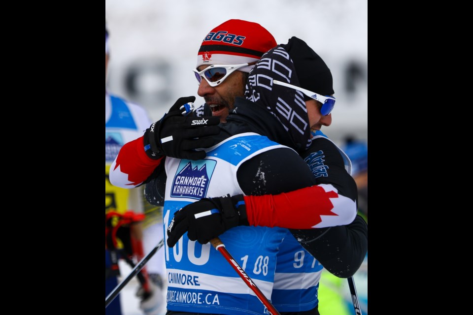 Vladimir Udalstov of Russia is congratulated by Brian McKeever of Canada after the men's sprint classic, visually impaired race final in the 2021 World Para Nordic Skiing World Cup at the Canmore Nordic Centre on Tuesday (Dec. 7). Udalstov won the bronze medal. EVAN BUHLER RMO PHOTO