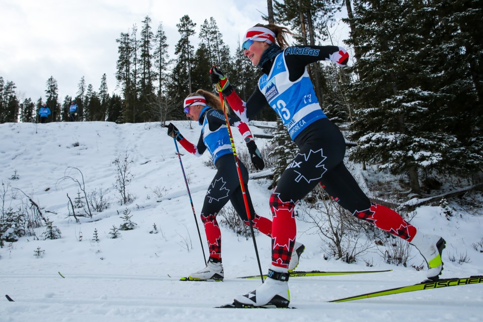 Natalie Wilkie of Canada, left, and Brittany Hudak of Canada ski in the women's sprint classic, standing race final at the 2021 World Para Nordic Skiing World Cup at the Canmore Nordic Centreon Tuesday (Dec. 7). Wilkie finished with the silver medal, while Hudak took home gold. EVAN BUHLER RMO PHOTO