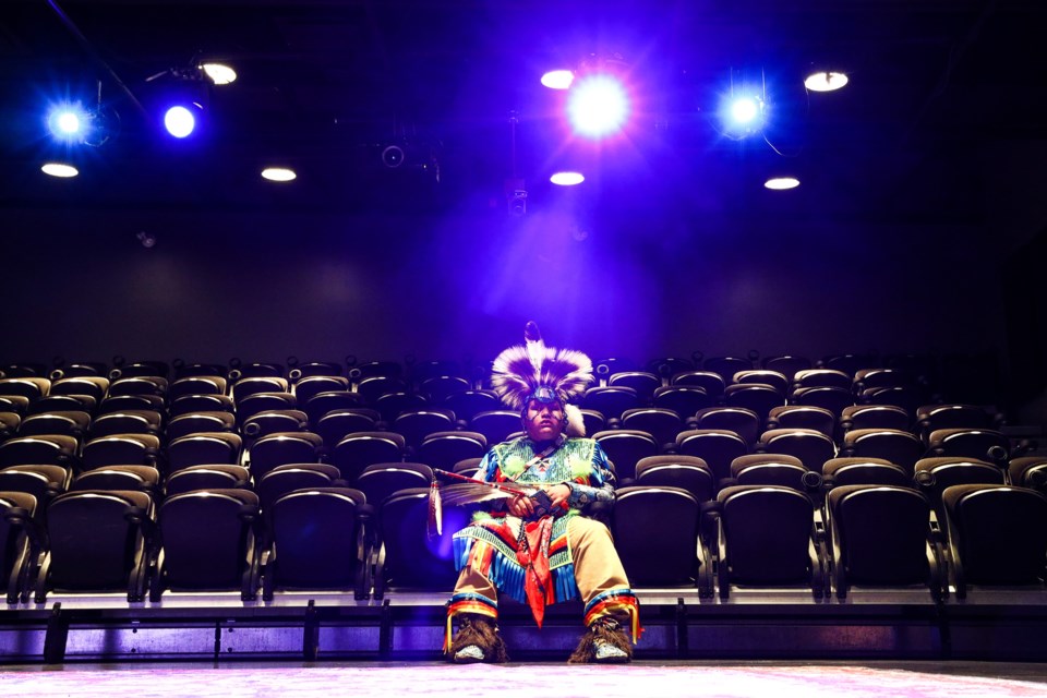 Dressed as a chicken dancer, Hardy Smalleyes, a member of the Stoney Nakoda Nation, sits in the empty theatre as he waits to rehearse before the start of the annual Stoney Christmas show at artsPlace in Canmore on Saturday (Dec. 18). EVAN BUHLER RMO PHOTO