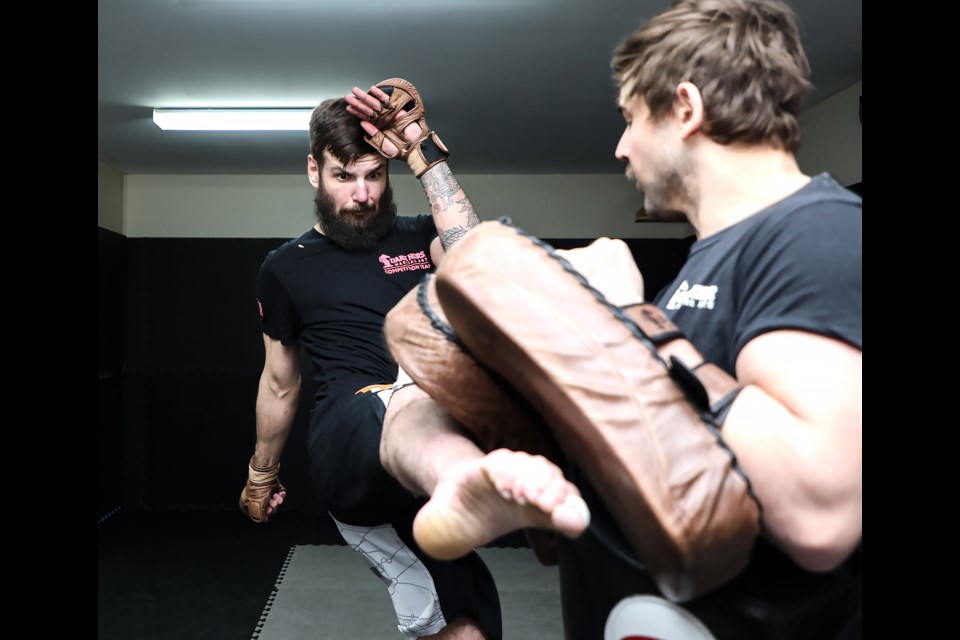 Mixed martial artist Travis Erlam, left, kicks while training with his sparring partner at Dark Horse Martial Arts in Canmore on Thursday (April 7).
JUNGMIN HAM RMO PHOTO