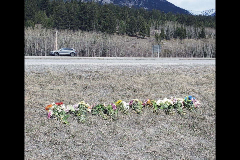 Flowers lay by the side of the Trans-Canada Highway near the Canmore Visitor Information Centre to memorialize the 20-year-old woman who was hit and killed early Sunday morning.

GREG COLGAN RMO PHOTO