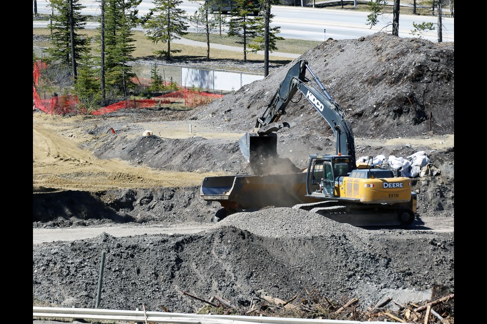 An excavator loads topsoil into a truck as part of the construction work being completed at The Gateway at Three Sisters commercial development on Friday (May 6).

GREG COLGAN RMO PHOTO