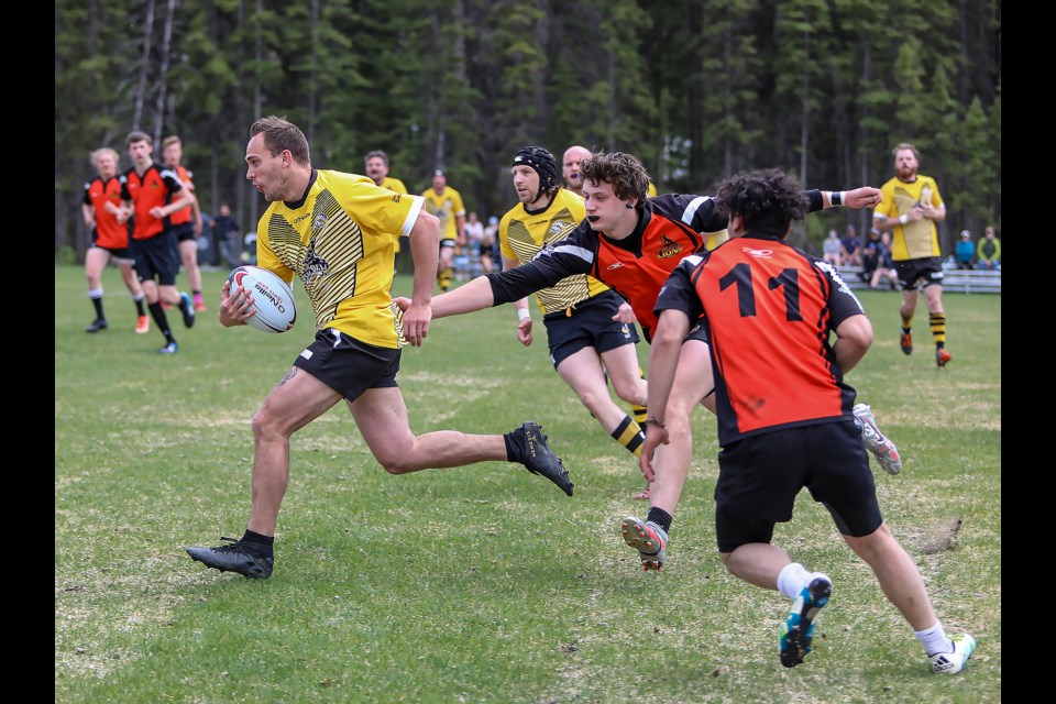 Banff Bears Mike Crabtree charges through Foothills Lions  players at the Banff recreation grounds on Saturday (June 11). The Banff Bears defeated the Foothills Lions, 24-0. JUNGMIN HAM RMO PHOTO