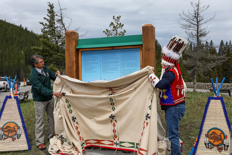 Siksika Nation Chief Ouray Crowfoot, right, and Banff National Park superintendent Salman Rasheed unveil the Castle Mountain signage in June. The official unveiling of the new sign was attended by representatives from both the Siksika Nation and Parks Canada. 

RMO FILE PHOTO