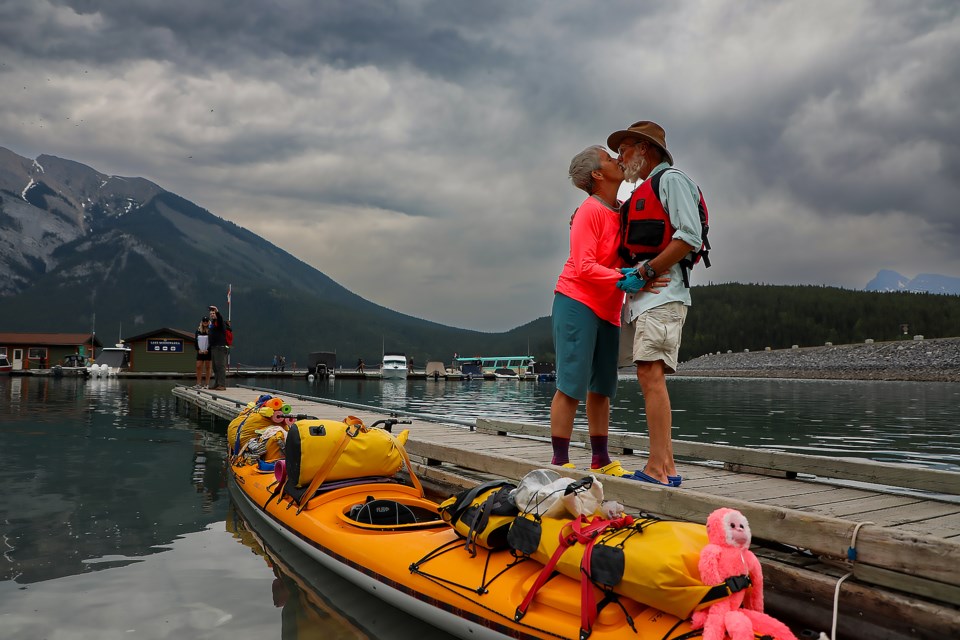 Linda Léveillée, left, and Louis Demers from Quebec get off the kayak and kiss at Lake Minnewanka in Banff on Tuesday (June 28). They are traveling all over Canada carrying kayak on RVs. JUNGMIN HAM RMO PHOTO