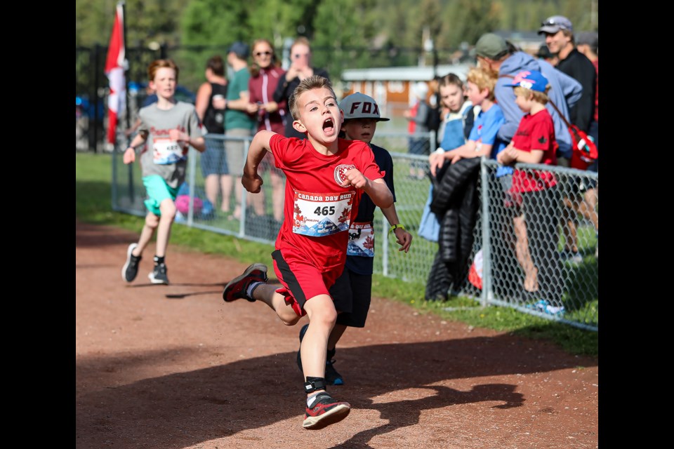 Tighe Preece (465) sprints for the finish line in the Canada Day family fun, run and walk on Friday (July 1) in Canmore. JUNGMIN HAM RMO PHOTO