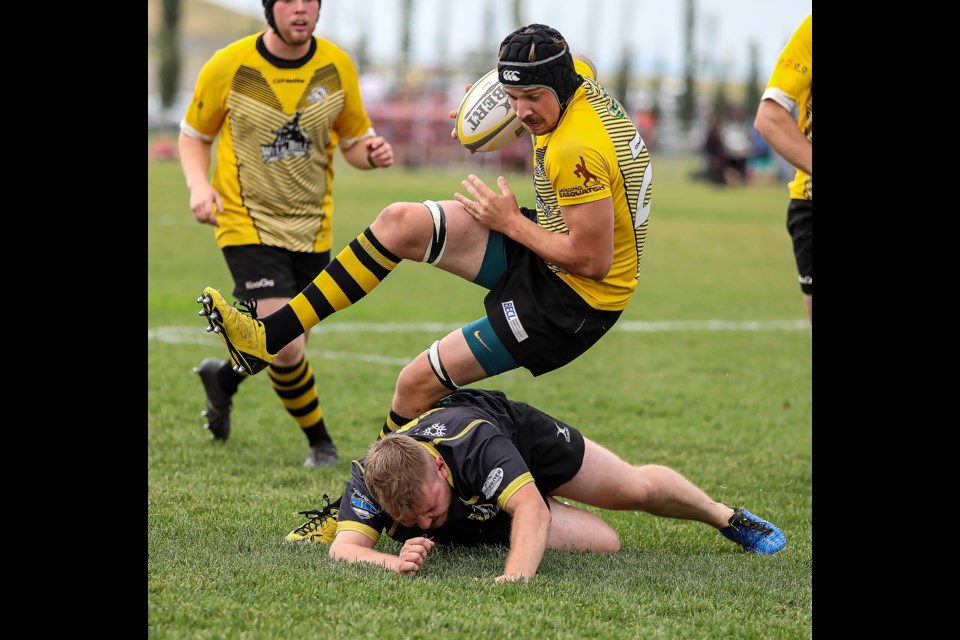 Banff Bears Kyle Mills is tackled by a Calgary Hornets player at the Calgary Rugby Union on Saturday (Aug. 20). Banff won 66-0 to move into first place in the standings. JUNGMIN HAM RMO PHOTO