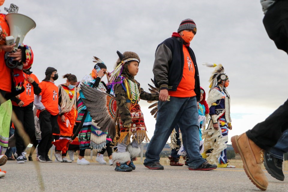 People walk from the McDougall Memorial United Church to the Morley United Church to raise awareness for residential school survivors and non-survivors on Sept. 30, 2021, the first annual National Day for Truth and Reconciliation. JESSICA LEE GREAT WEST MEDIA