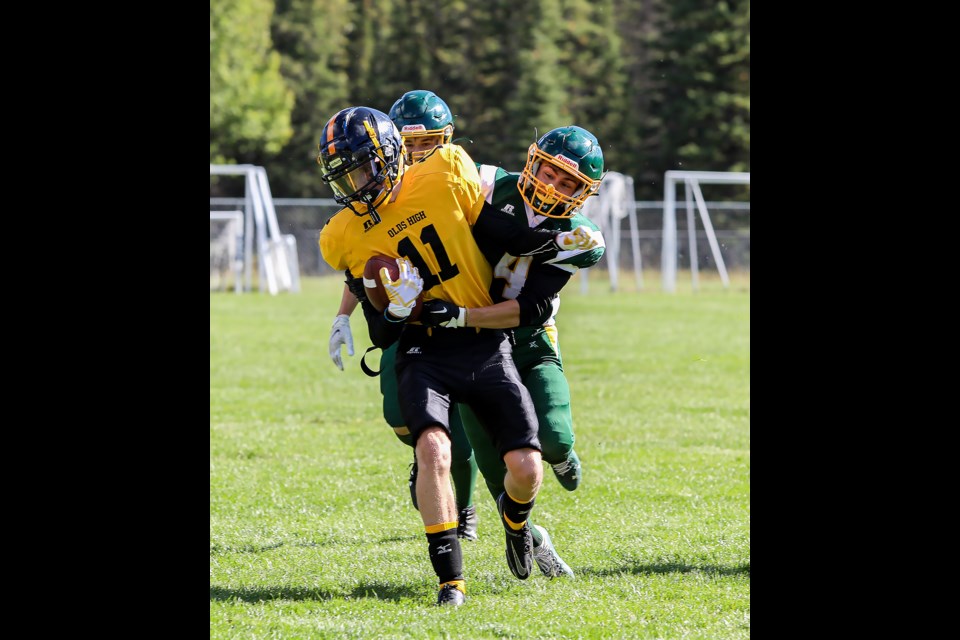 Canmore Wolverines Evren Odyakmaz (No. 4) makes a tackle against the Olds runningback during a game at Millennium Park on Saturday (Sept. 24). JUNGMIN HAM RMO PHOTO