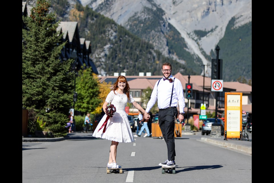 After their wedding, Robyn Boyko, left, and Cody Boyko skateboard on Banff Avenue (Oct. 1). JUNGMIN HAM RMO PHOTO