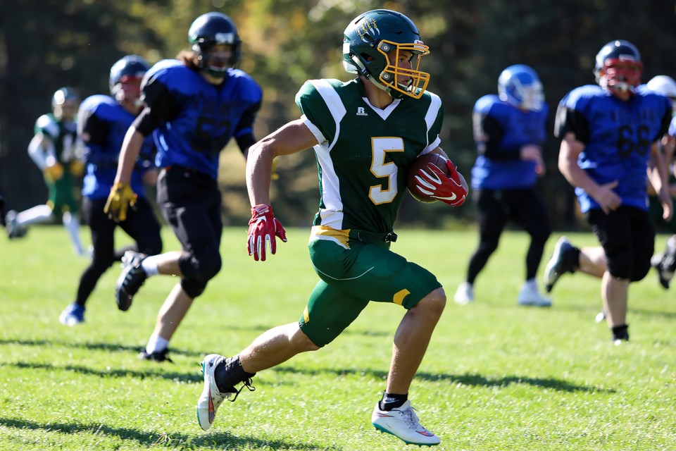 Canmore Wolverines Bryton Kapitza (No. 5) runs for a touchdown in a game at Millennium Park in October 2022. JUNGMIN HAM RMO PHOTO