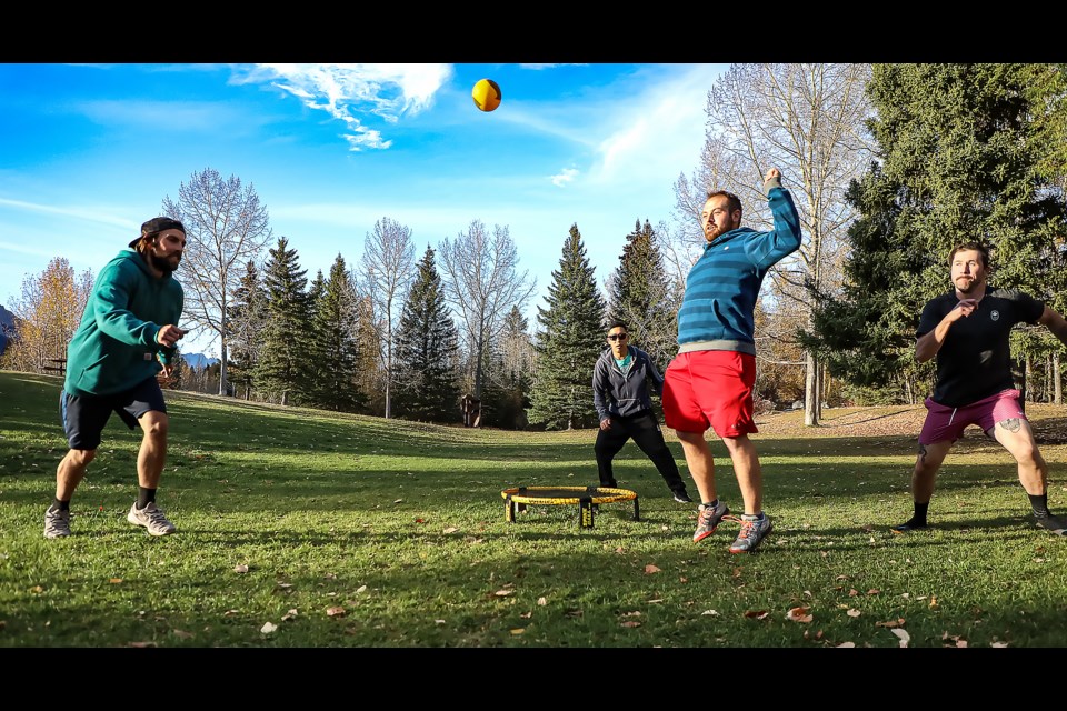 People play Roundnet during a warm autumn day at Riverside Park in Canmore on Thursday (Oct. 13). From left: Khris Alcorn, Future Todoroki, Eli Trost and Zachary Flynn. JUNGMIN HAM RMO PHOTO