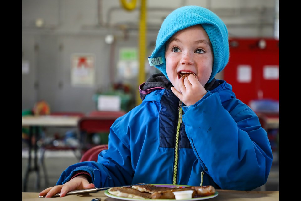 Mavi Lamarche enjoys pancakes made by Canmore firefighters at the annual fire prevention week pancake breakfast at the Canmore Fire Hall on Saturday (Oct. 15). JUNGMIN HAM RMO PHOTO