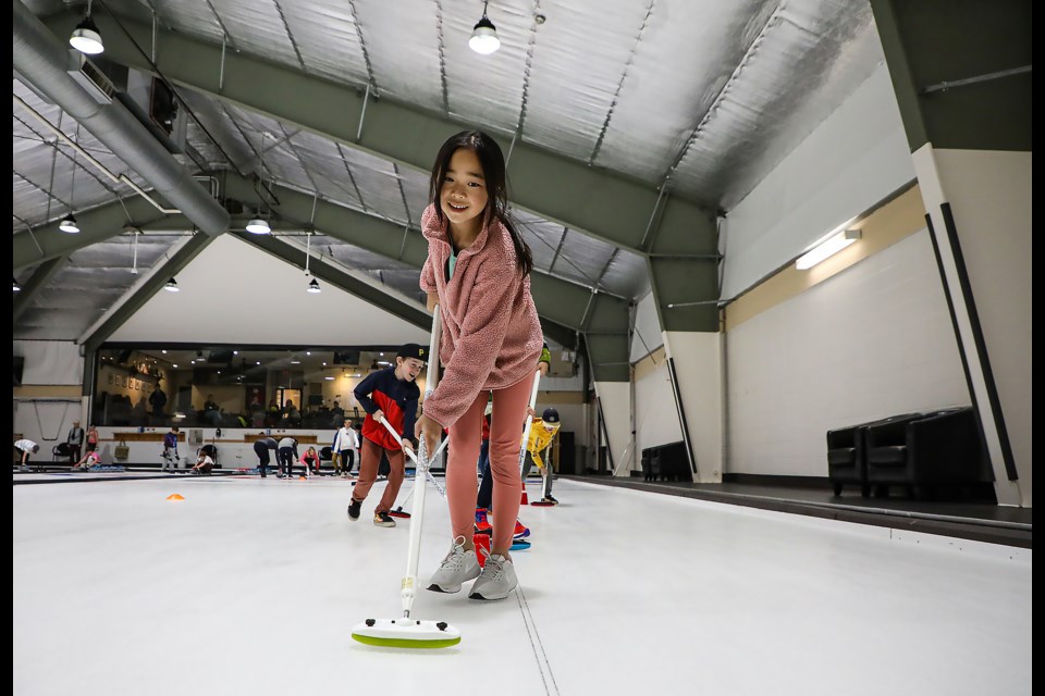 Angee Xu learns to sweep at the free Junior Curling Pizza Night at the Canmore Golf & Curling Club in Canmore on Wednesday (Oct. 19). JUNGMIN HAM RMO PHOTO 