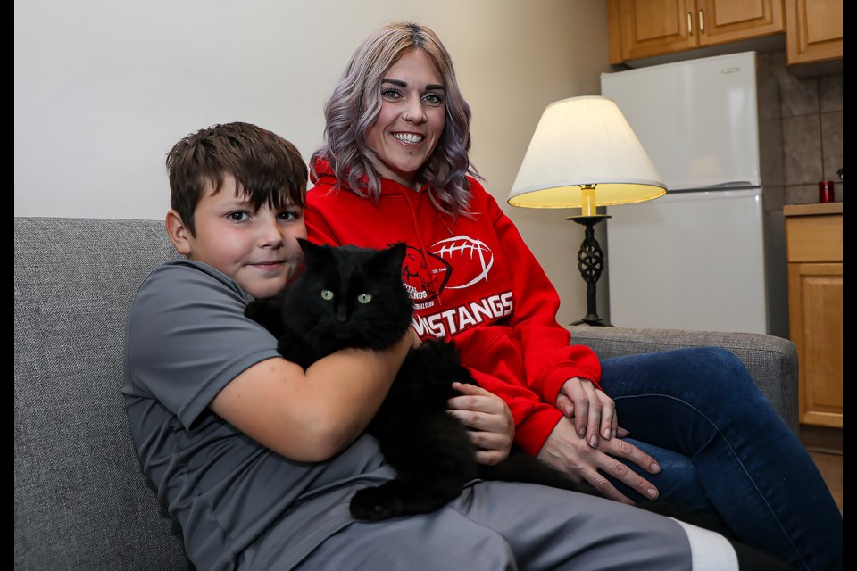 Jody Hudey, right, and her son Dolphis Seguin hold Gustophe, a cat that went missing in Spray Valley in Kananaskis Country and was rescued on Friday (Oct. 21). JUNGMIN HAM RMO PHOTO 