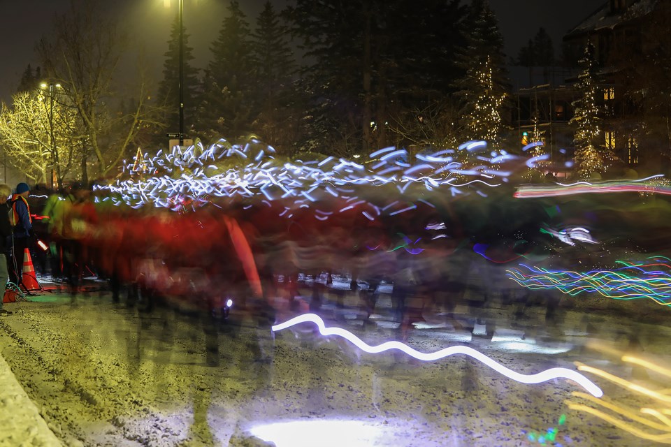 A long exposure shows the 2022 Banff Winterstart 5 Miler Night Run racers blast off from the start line at the 500 block of Banff Avenue in front of the Banff Caribou Lodge on Saturday (Nov. 5). JUNGMIN HAM RMO PHOTO