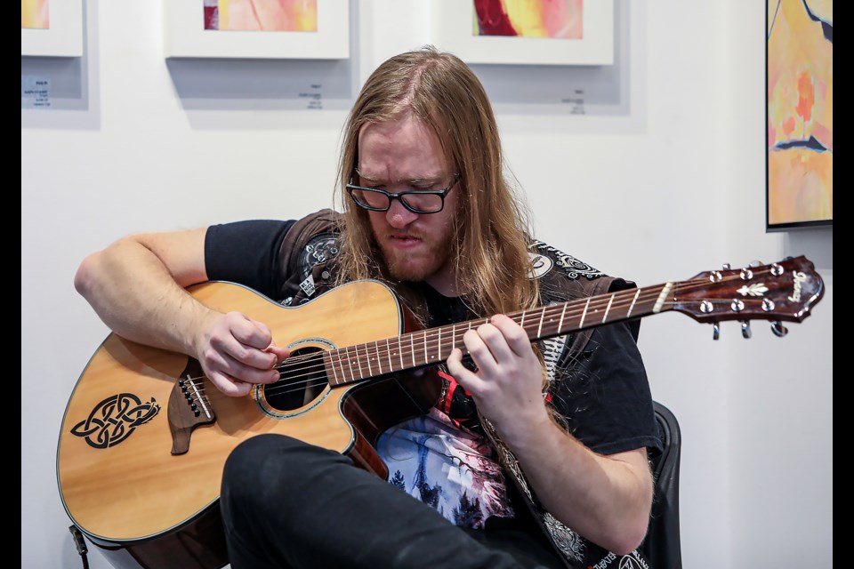 Banff's Kasey Nolan plays guitar at the Alternative, Metal & Punk Festival (AmpFest II) at artPlace in Canmore on Saturday (Nov.12). JUNGMIN HAM RMO PHOTO 