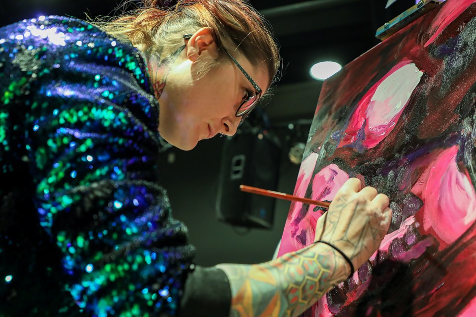 Veronique Wiebe paints in the first round of Creative Combat 8.0 at artsPlace in Canmore on Saturday (Nov. 19). The Creative Combat 8.0 fundraising event had 12 artists compete to create art in 20 minutes. JUNGMIN HAM RMO PHOTO 
