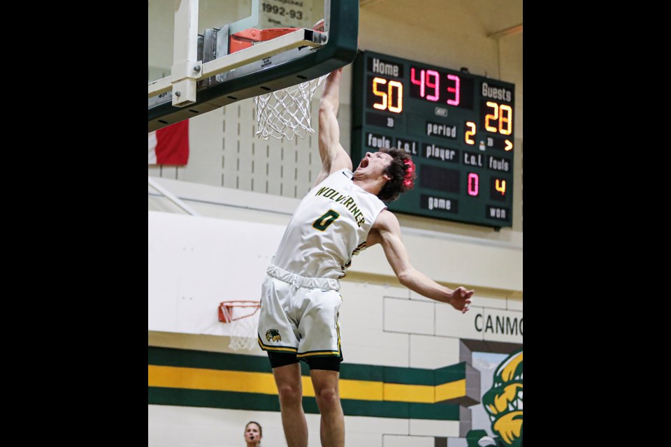 Canmore Wolverines Ethan Fisher dunks against a W.H. Croxford during the senior boys basketball tournament at Canmore Collegiate High School on Friday (Dec. 2). JUNGMIN HAM RMO PHOTO