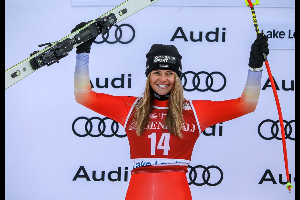 Swiss star Corinne Suter celebrates on the podium at the 2022 Lake Louise Alpine World Cup. JUNGMIN HAM RMO PHOTO