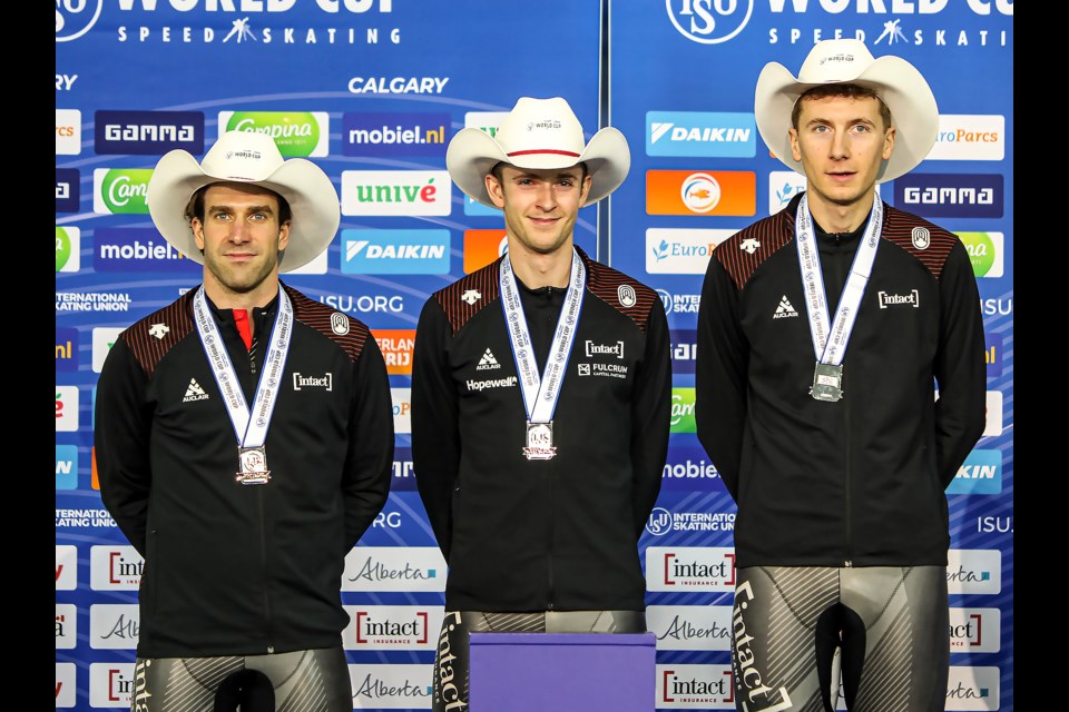 Connor Howe, right, Antoine Gélinas-Beaulieu and Hayden Mayeur of Canada celebrate on the podium in the men's team pursuit race at the ISU speed skating world cup in Calgary on Friday (Dec. 9). The trio won silver. JUNGMIN HAM RMO PHOTO