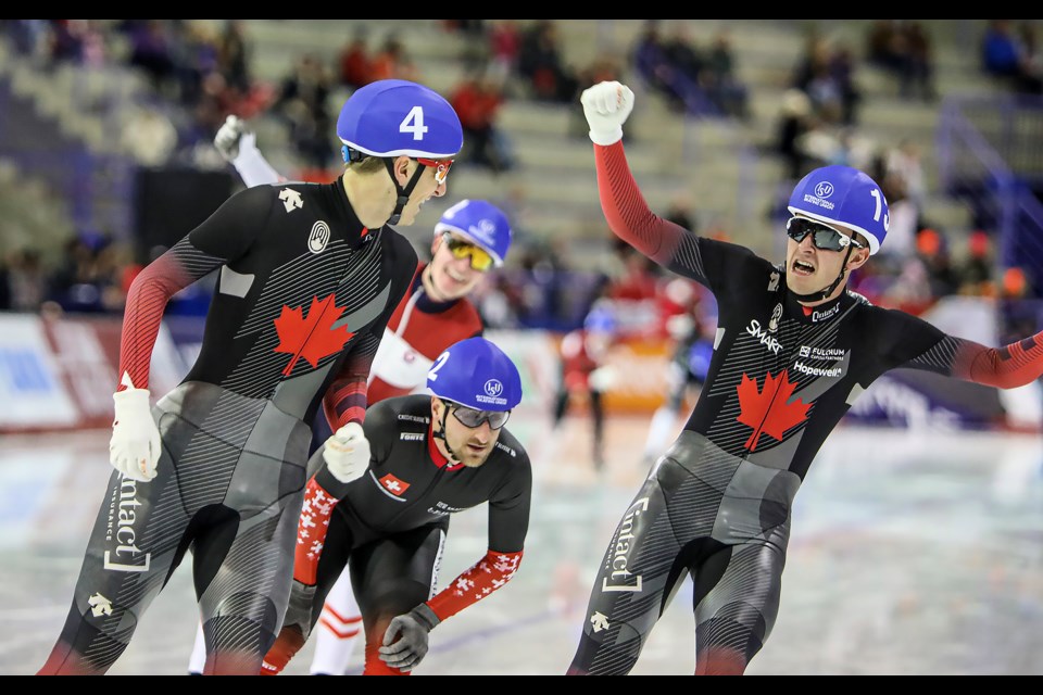 Canada's Connor Howe (No. 4), who finished second, and Canada's Hayden Mayeur (No. 13), who finished third, cheer as they crosse the finish line in the men's mass start final at the ISU speed skating world cup in Calgary on Sunday (Dec. 18).  JUNGMIN HAM RMO PHOTO