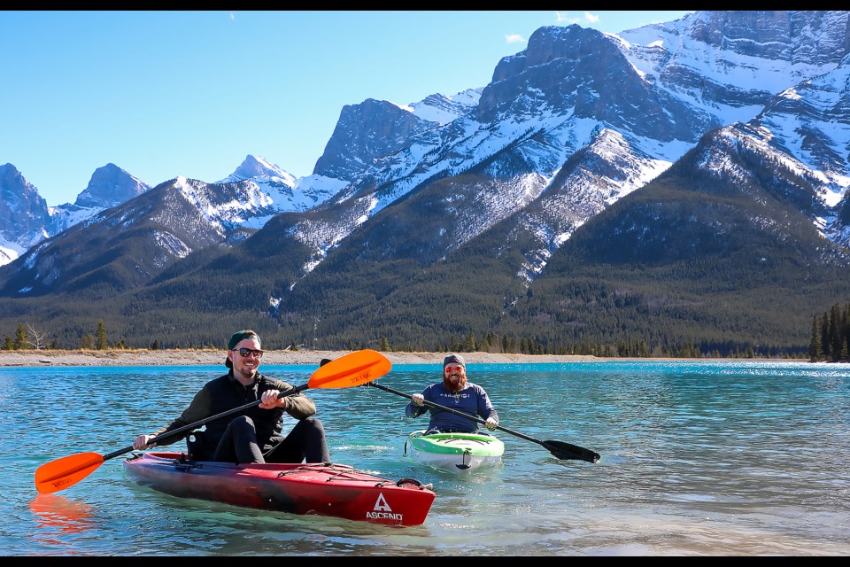 Brendan Farrell, right, and Chris Turner, kayak and enjoy the warm spring weather at Rundle Forbay Reservoir in Canmore on April 6. JUNGMIN HAM RMO PHOTO