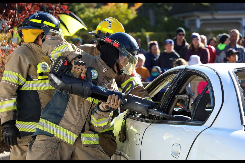 Firefighter Yosuke Mizuno cuts a vehicle's doors during a vehicle extraction demonstration at the annual Fire Prevention Week pancake breakfast and Banff Fire Hall Open House on Oct. 15. 

JUNGMIN HAM RMO PHOTO 