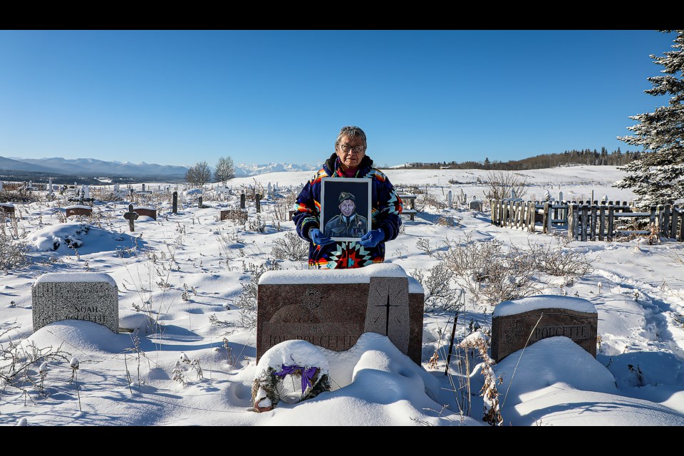 Tina Fox poses with a portrait of her uncle, Joe Poucette, at Big Stoney Cemetery in Morley on Nov. 8. Rifleman Poucette is the only person from Stoney Nakoda First Nation to serve in Second World War. JUNGMIN HAM RMO PHOTO