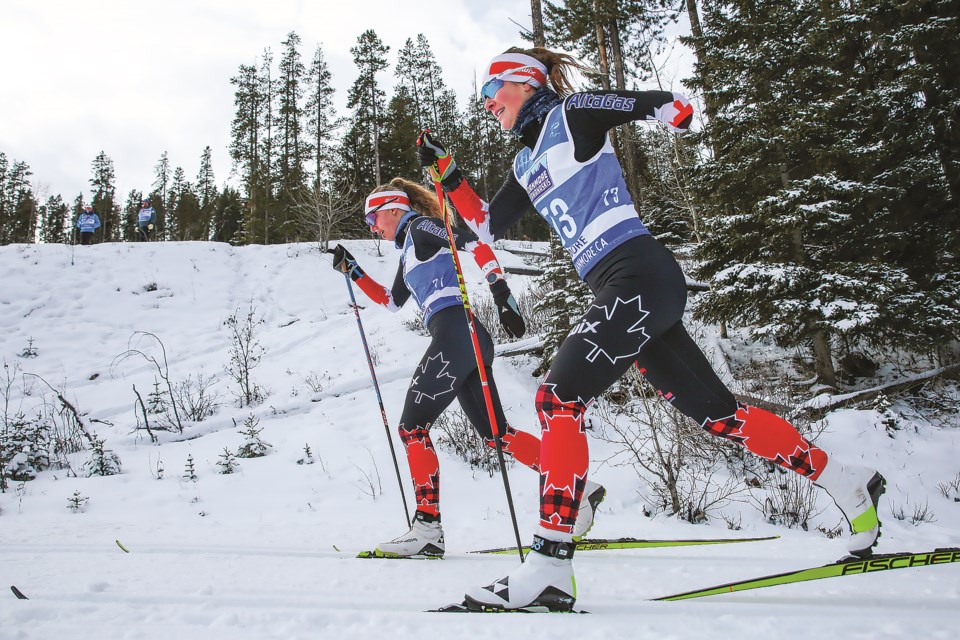 Natalie Wilkie of Canada, left, and Brittany Hudak of Canada ski in the women's sprint classic, standing race final in the 2021 World Para Nordic Skiing World Cup at the Canmore Nordic Centre in Dec. 2021. RMO FILE PHOTO