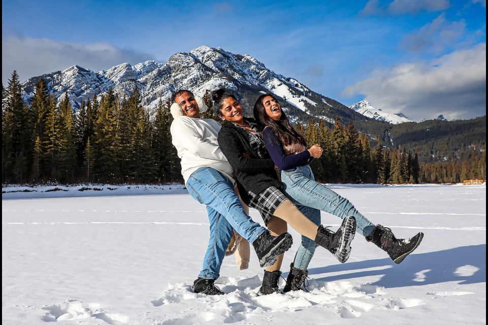 A family from Calgary enjoy taking pictures on the snowy, frozen Bow River in Banff on Thursday (Jan. 12). From left; Upendra Mokani, Parul Mokani and Devangi Mokani. JUNGMIN HAM RMO PHOTO