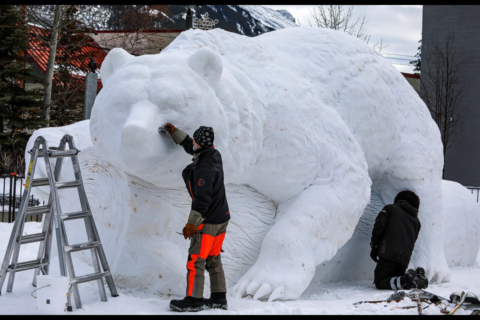 David Ducharme, left, from British Columbia and Dmitrii Klimenko from Russia carve a giant snow sculpture on Banff Avenue named "The Boss" for the SnowDays Winter Festival on Tuesday (Jan. 17). SnowDays Winter Festival runs Jan.18-29. JUNGMIN HAM RMO PHOTO