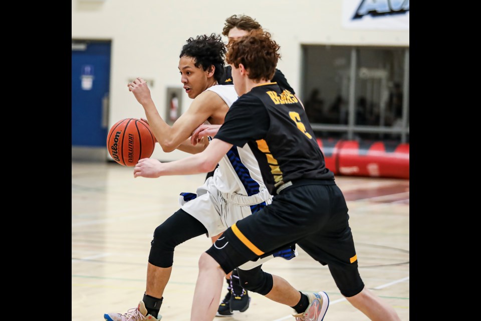 OLS Avalanche Raymond Vargas, left, drives to the basket against the Banff Bears during the JV boys gold basketball game at OLS on Thursday (Jan. 26). JUNGMIN HAM RMO PHOTO