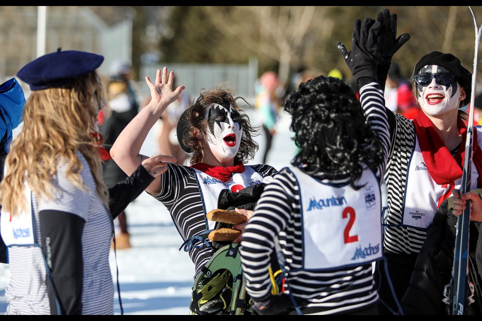 Team French Kiss members hi-five and celebrate the completion at the 2023 Mountain Madness Relay Race on Friday (Feb. 3). JUNGMIN HAM RMO PHOTO