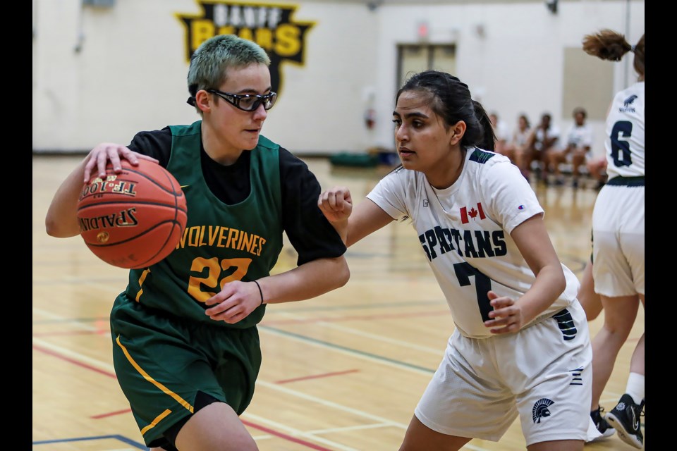 Canmore Wolverines Clea Chevance, left, drives to the basket against the Strathcona-Tweedsmuir School (STS) Spartans during the senior girls basketball tournament at Banff Community High School on Friday (Feb. 10). The Wolverines beat the Spartans 54-27. JUNGMIN HAM RMO PHOTO
