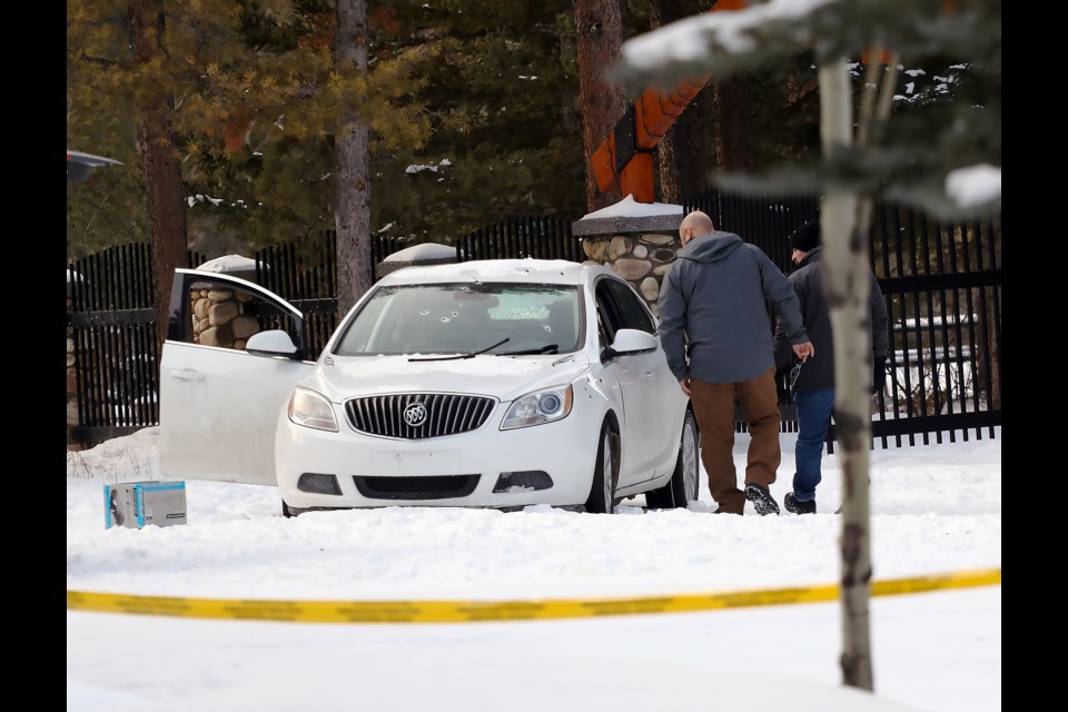 RCMP investigators look into a white Buick with multiple bullet holes that remained behind police tape near 11 Avenue and 15 Street on Saturday (Feb. 25). The vehicle was removed Saturday evening as RCMP completed the on scene investigation.

GREG COLGAN RMO PHOTO