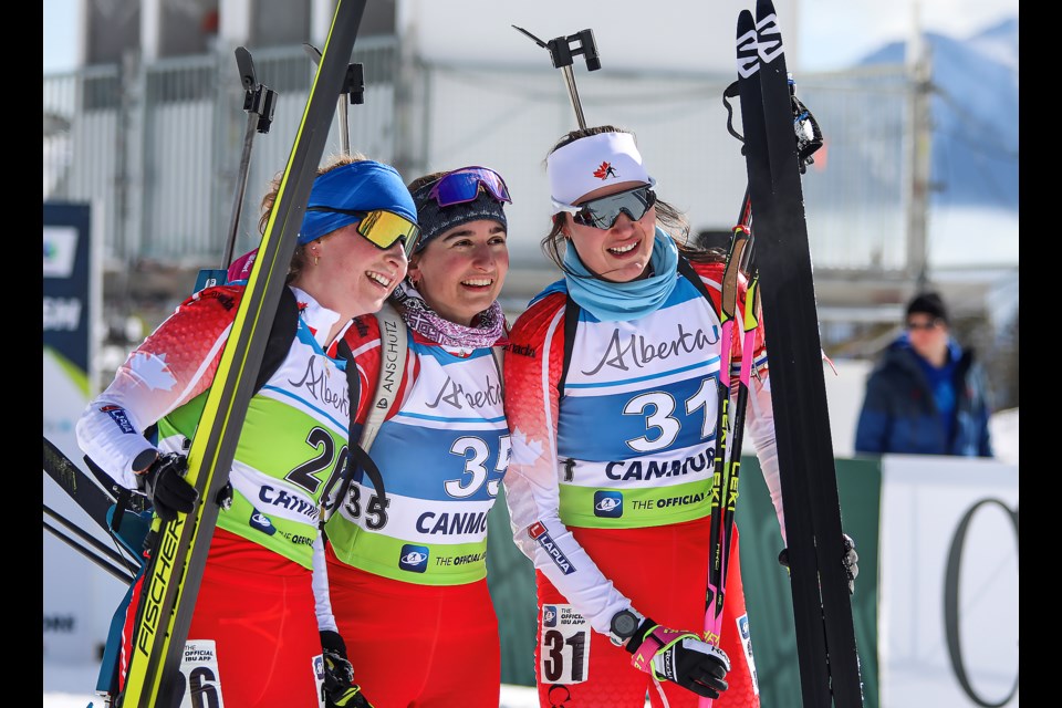 Canadians Shilo Rousseau, left, Zoe Pekos and Gillian Gowling pose at the finish line at the Canmore IBU Cup at the Canmore Nordic Centre on Tuesday (Feb. 28). JUNGMIN HAM RMO PHOTO 