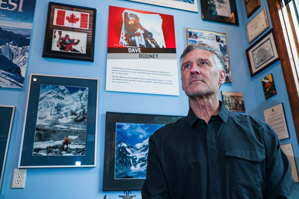Dave Rodney poses in front of Mount Everest memorabilia and photos at his house in Canmore on Friday (March 10). JUNGMIN HAM RMO PHOTO
