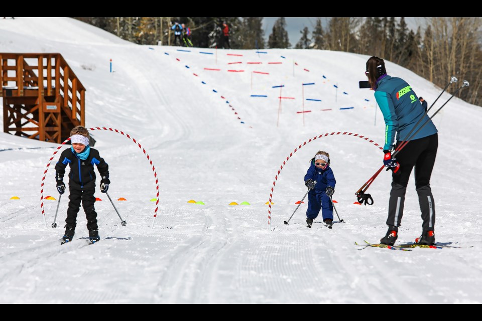 Henry Adam, 6, left, competes with his sister, Charlotte Adam, on a ski skills course in Nordiq Albertaâs End of Season Bash at the Canmore Nordic Centre on Saturday (March 25).JUNGMIN HAM RMO PHOTO