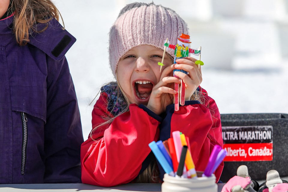 Kristina Atkins, 5, smiles with her craftwork at the craft table in Nordiq Albertaâs End of Season Bash at the Canmore Nordic Centre on Saturday (March 25). JUNGMIN HAM RMO PHOTO