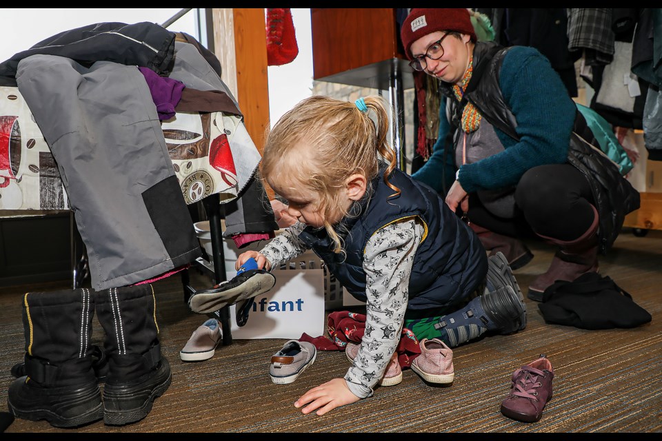 Rhys Willett, 3, picks shoes at Swap-o-Rama, a free clothing sharing event, at the Canmore Public Library on Saturday (April 1). JUNGMIN HAM RMO PHOTO 