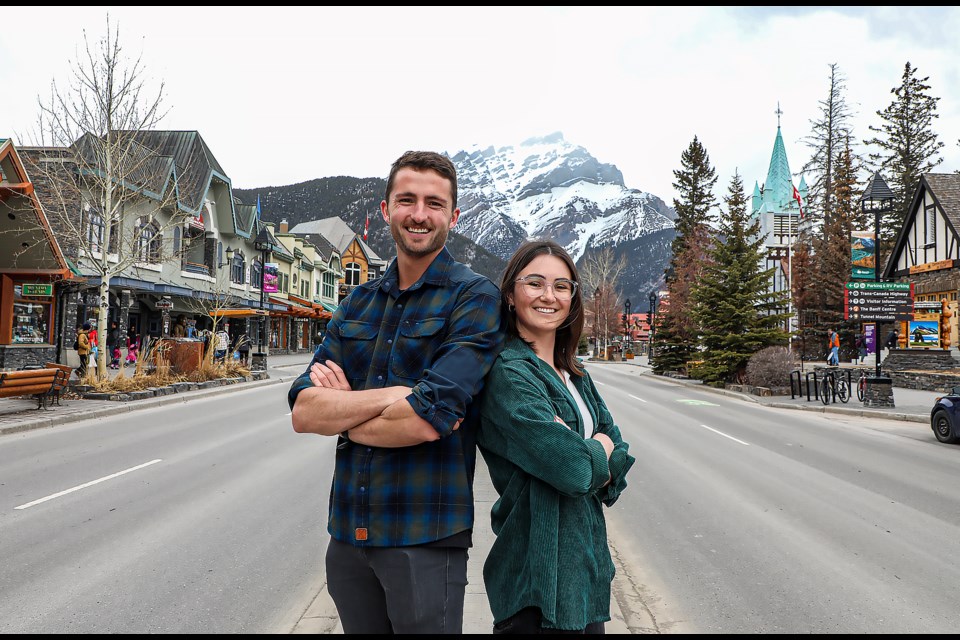 Jesse Kitteridge, left, and Alexandra King pose on Banff Avenue on Tuesday (April 18). Kitteridge and King are starting the Moraine Lake Bus Company, offering an early morning shuttle to Moraine Lake. JUNGMIN HAM RMO PHOTO 