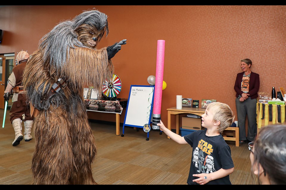 Monty Ward, 4, high-fives Star Wars character Chewbacca during the Star Wars Day Family Celebration event at the Canmore Public Library on Thursday (May 4). JUNGMIN HAM RMO PHOTO